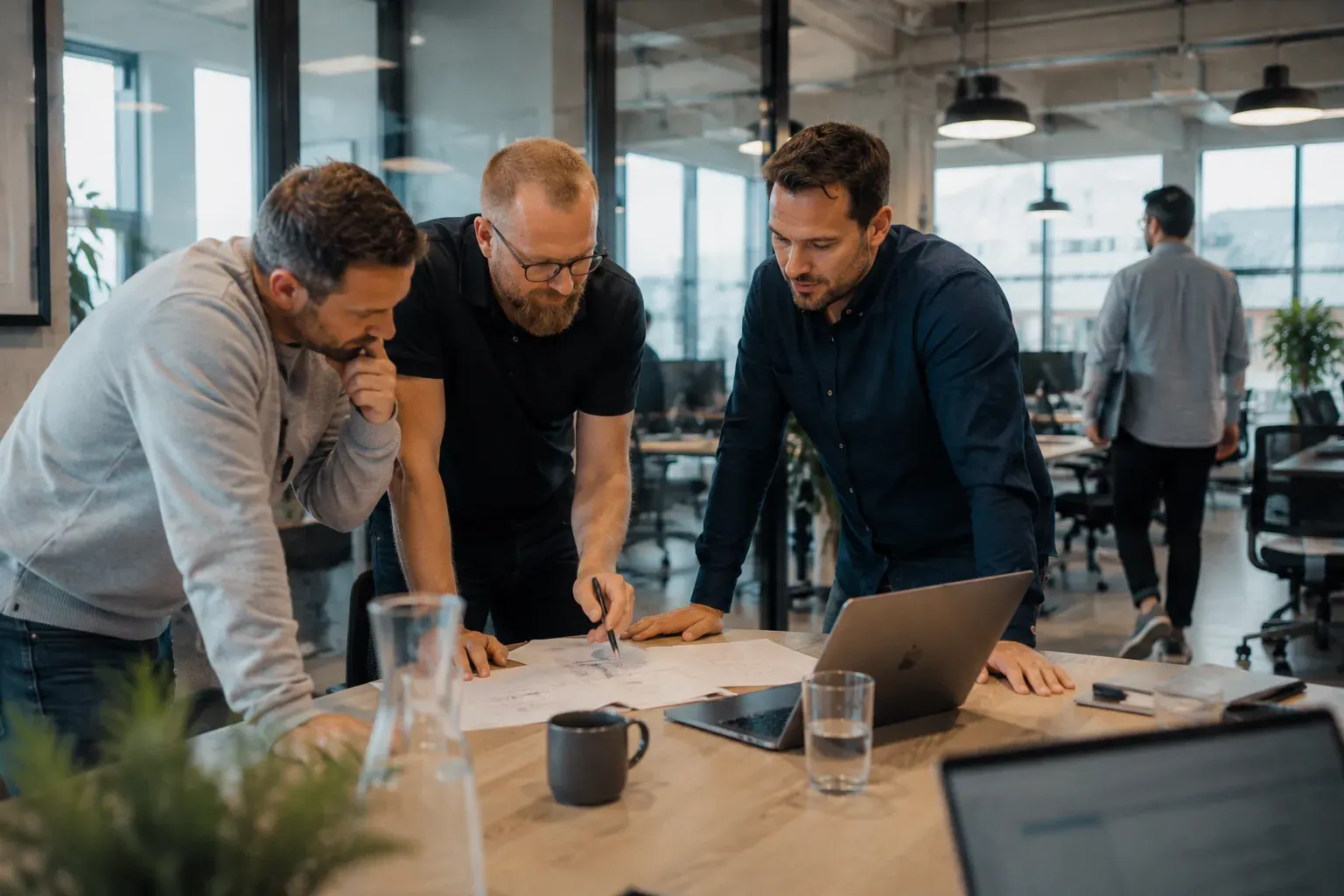 Three developers reviewing an MCP server on a laptop before the directory submission